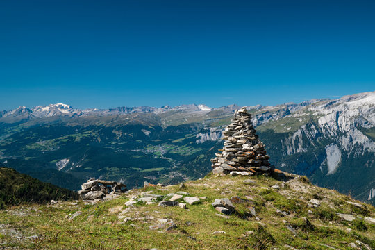 Stone Cairn on Mountain Peak Overlooking Panoramic Alpine Views in Brambr&uuml;esch, Graub&uuml;nden, Switzerland