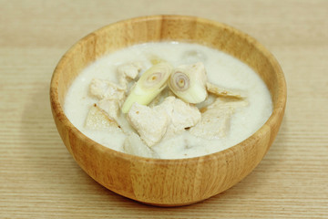 Thai sour chicken soup in wood bowl