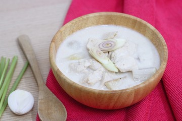 Thai sour chicken soup in wood bowl