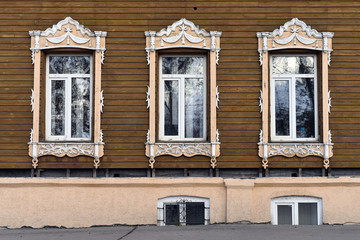 Fototapeta na wymiar Wooden decorating of windows old residential buildings