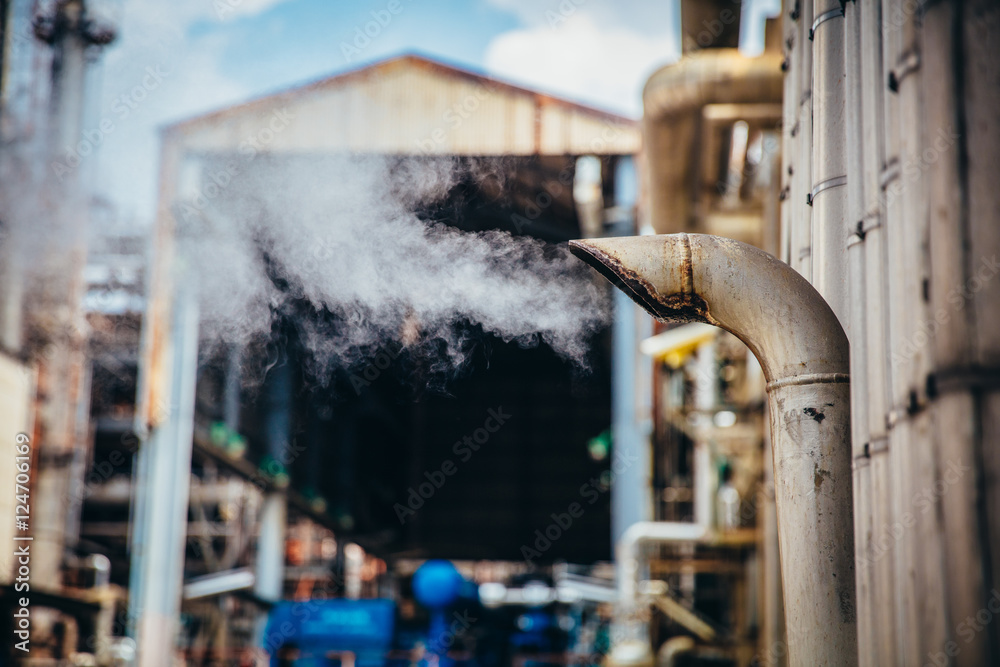 Wall mural industrial zone,the equipment of oil refining,close-up of industrial pipelines of an oil-refinery pl