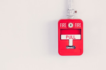 Old red box fire alarm  on cement wall