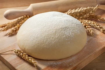  Fresh dough on a board with ears of wheat and rolling pin. © Timmary