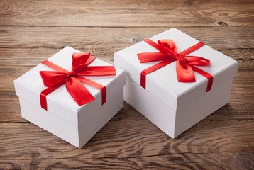 White box with a red bow on the old board