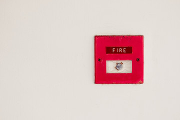 Old red box fire alarm  on cement wall