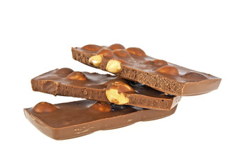 Milk chocolate bar with nuts on a white background, closeup