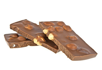 Milk chocolate bar with nuts on a white background, closeup