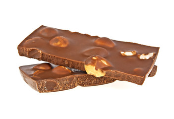 Milk chocolate bar with nuts on a white background, closeup