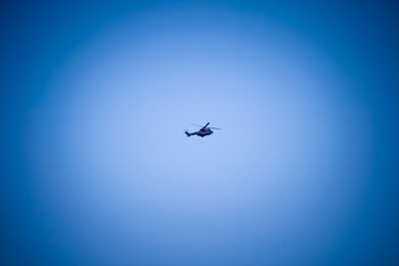 Military helicopter in deep blue sky