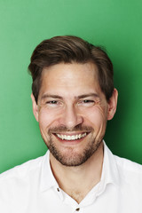 Confident man smiling in studio, portrait