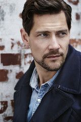 Blue guy in navy jacket, looking away