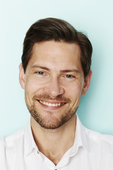 Smiling man in studio, portrait