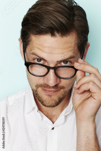 Portrait Of Man Adjusting Glasses Photo Libre De Droits Sur La Banque