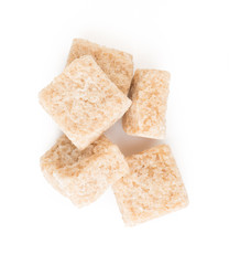 pieces of brown cane sugar isolated on white background Top view.