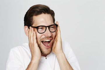 Handsome man in spectacles calling, studio