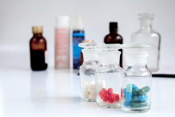 glass jars of pills - home first aid kit