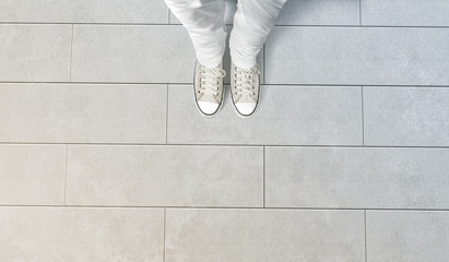Person taking photo of his feet stand on concrete floor, isolated, top view, clipping path. Ground...