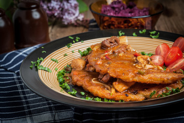 Potato pancakes with meat stew served on a plate.