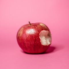 red apple on pink background