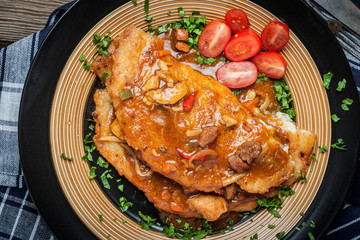 Potato pancakes with meat stew served on a plate.
