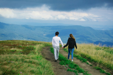 Fototapeta na wymiar Couple walking on field road