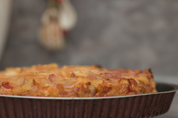 Apple pie on the plate. Golden crust. The interior of the kitchen.