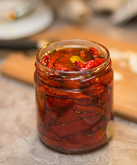 Fototapeta na wymiar Sun-dried tomatoes in a glass jar.