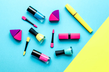 concept cosmetic set on blue and yellow background top view