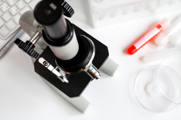 microscope with test tubes on white background close up