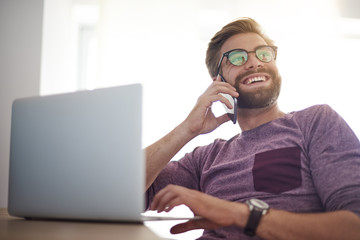 Happy man doing buisness in the home office