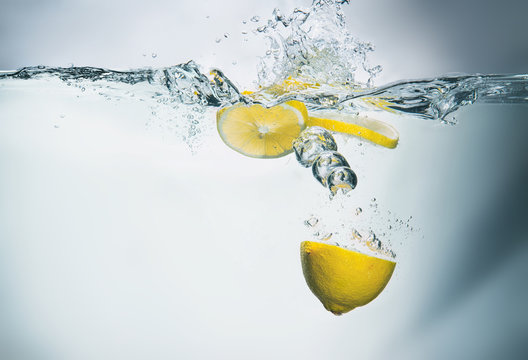 Fresh lemon in water with splash