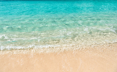 Fototapeta na wymiar Beautiful marine view on sea coast line with clean wavy surf water on sandy beach