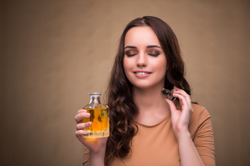 Young woman with bottle of perfume