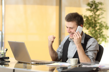 Excited businessman on the phone