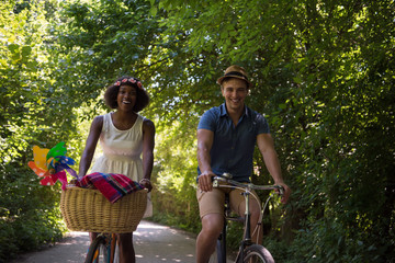 Young multiethnic couple having a bike ride in nature