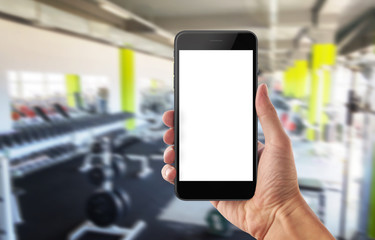 Fototapeta na wymiar Mobile phone in sport gym. Isolated white screen for mockup.