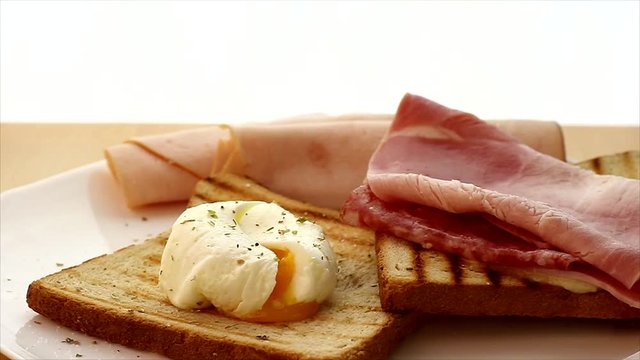 Great breakfast, eggs Benedict, toast, ham, salami, spices, real food video, organic food. 