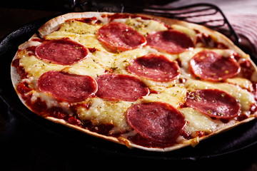 Spicy salami tortilla pizza with melted cheese