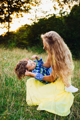 beautiful young mother with her son together in a park