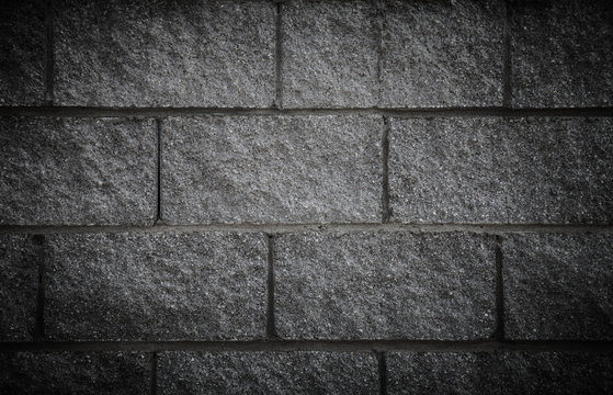 Wall of new gray bricks. Urban background. Toned