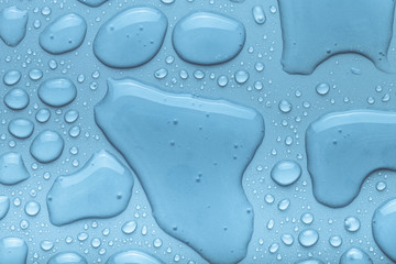 Drops of water on a color background. Blue. Toned