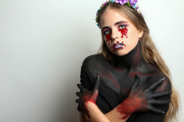 Beautiful girl with creative make-up for the Halloween party