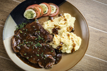 beef steak meal with mashed potato and gravy sauce
