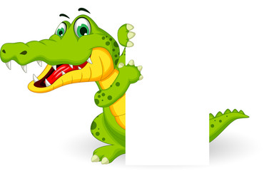 Fototapeta premium funny crocodile cartoon posing with blank sign