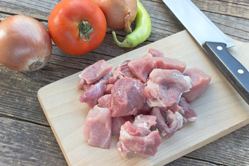 Chopped pork meat for goulash on wooden board