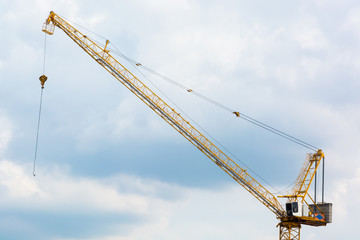 Yellow crane and blue sky on building site