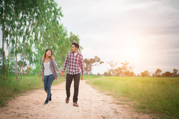 Young hipster couple walking on rural road enjoying with nature,