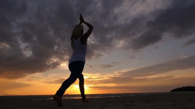Yogi Woman Practicing Yoga on Tropical Beach at Sunset