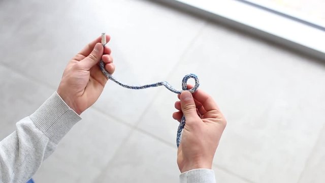 Bowline knot. Process of tying Bowline process is a top view on the gray background