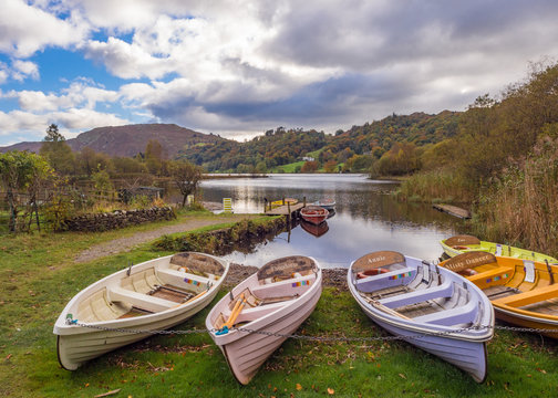 Rowing boats on Lake Grasmere at Autumn, Cumbria, UK